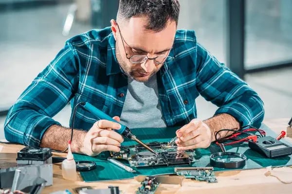 depositphotos_184999614-stock-photo-hardware-engineer-glasses-soldering-parts